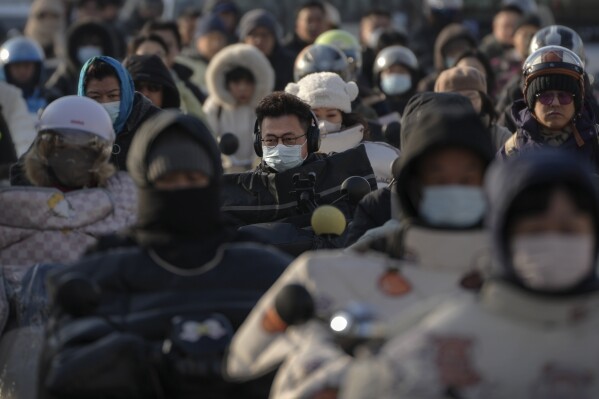 Drivers ride riding in the street in the street during the breakfast of Lokha on 26 March, 2025. (AP photo / andy Wong)